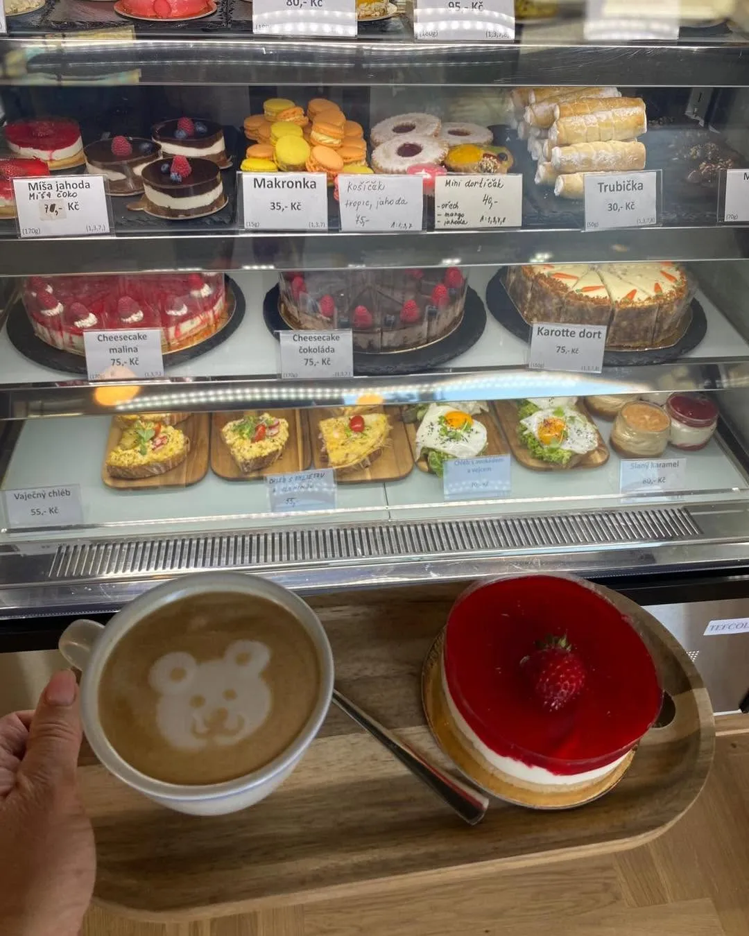 Vitrína se zákusky a cappuccino s medvídkem